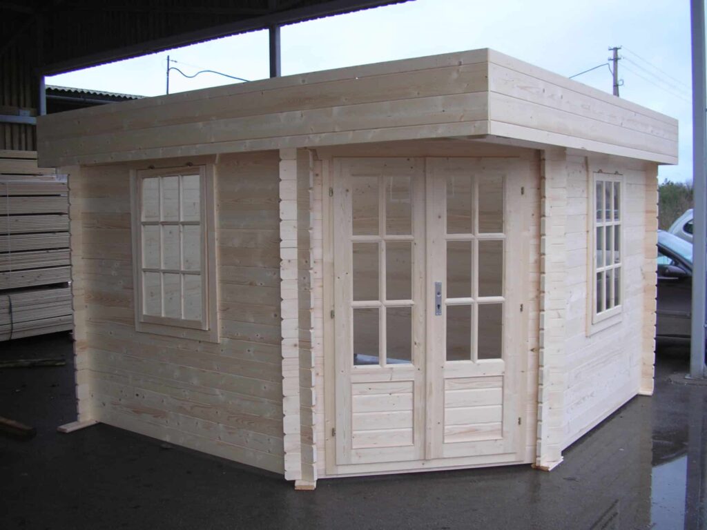 a small wooden building with windows