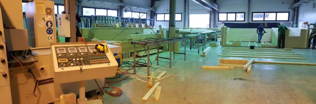 a large room with wood planks and machinery