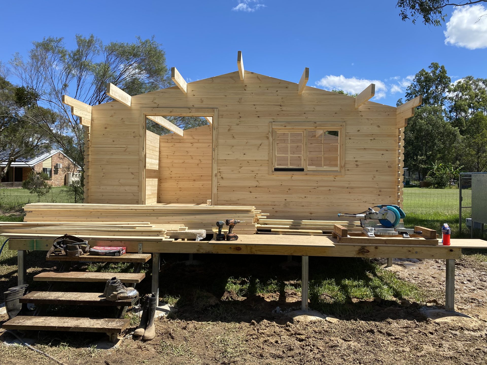 Front gable of a solid log cabin kit with the roof structure going on